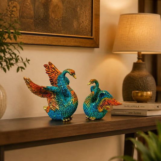 Colourful swan couple decorative figurines in vibrant turquoise blue and orange-gold tones for elegant home and table décor.