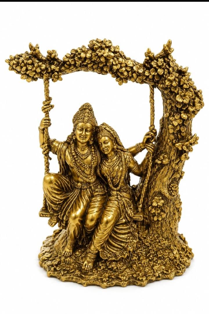 A golden brass-colored metal sculpture of a couple sitting on a swing under a leafy arch, set against a plain white background.